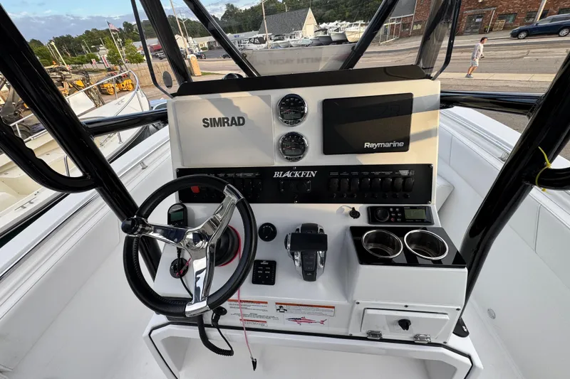 Slide: The Image of 2020 Blackfin 212 CC boat dashboard with Simrad and Raymarine electronics. - 14