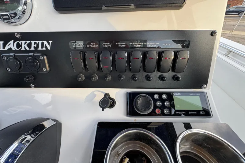Slide: The Image of Control panel of a 2020 Blackfin 212 CC boat with switches and a Fusion stereo. - 19