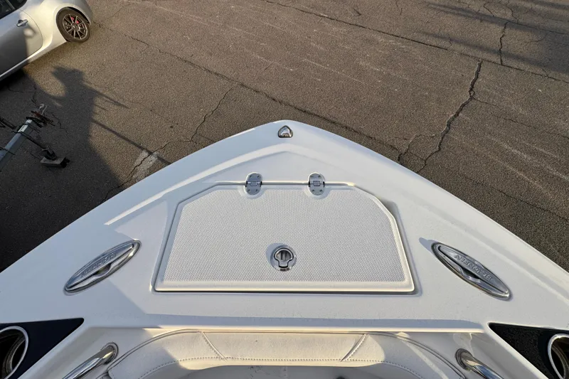 Slide: The Image of Bow of 2020 Blackfin 212 CC boat on pavement, featuring storage hatch and cleats. - 25