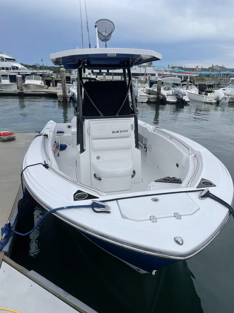 Slide: The Image of 2020 Blackfin 212 CC boat docked at marina, featuring sleek design and spacious deck. - 26