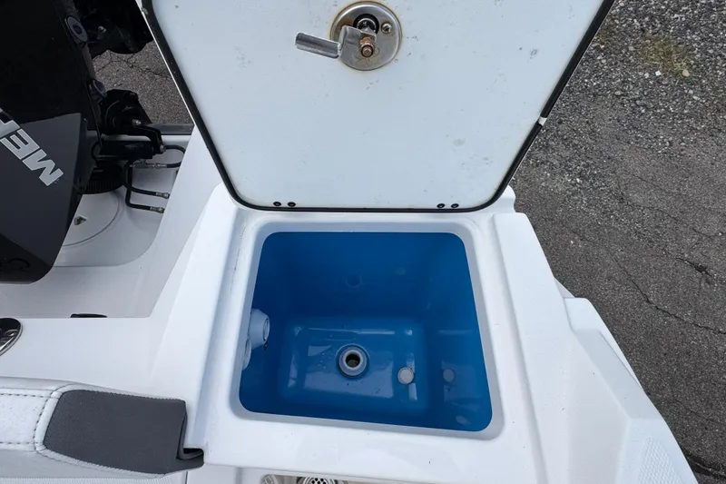 Slide: The Image of Open storage compartment on 2020 Blackfin 212 CC boat, featuring a blue interior. - 8