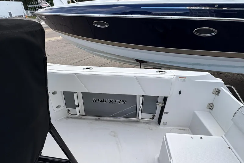 Slide: The Image of 2020 Blackfin 212 CC boat interior with sleek white seating and storage. - 9