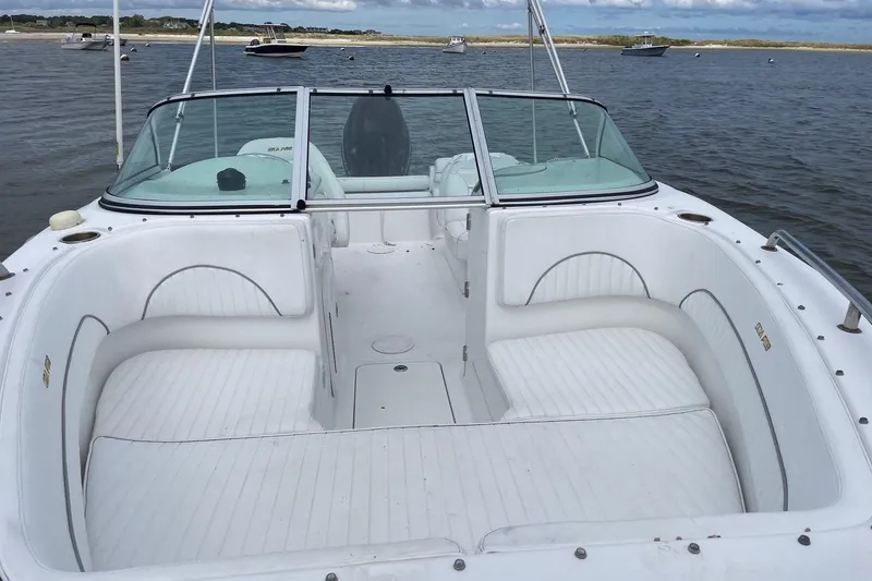 Slide: The Image of 2007 Sea Pro 216 boat with spacious seating, docked on calm waters. - 3