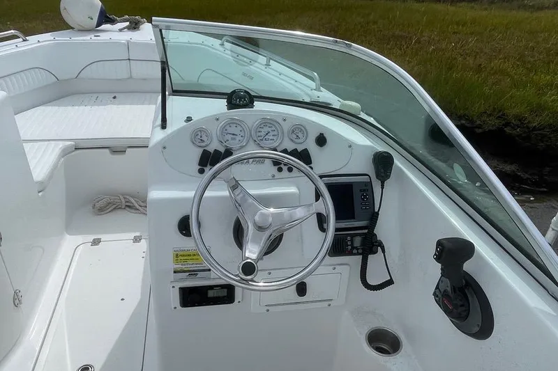 Slide: The Image of 2007 Sea Pro 216 boat dashboard with steering wheel and navigation controls. - 6