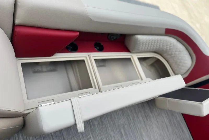 Slide: The Image of 2026 Godfrey SWEETWATER 2286 SB boat interior with red and beige seating and storage compartments. - 11
