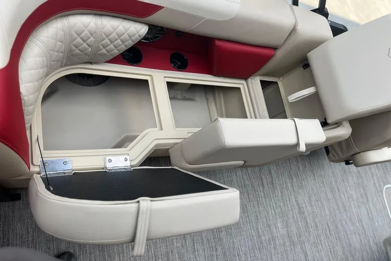 Slide: The Image of 2026 Godfrey SWEETWATER 2286 SB boat interior with open storage compartments and cushioned seating. - 13