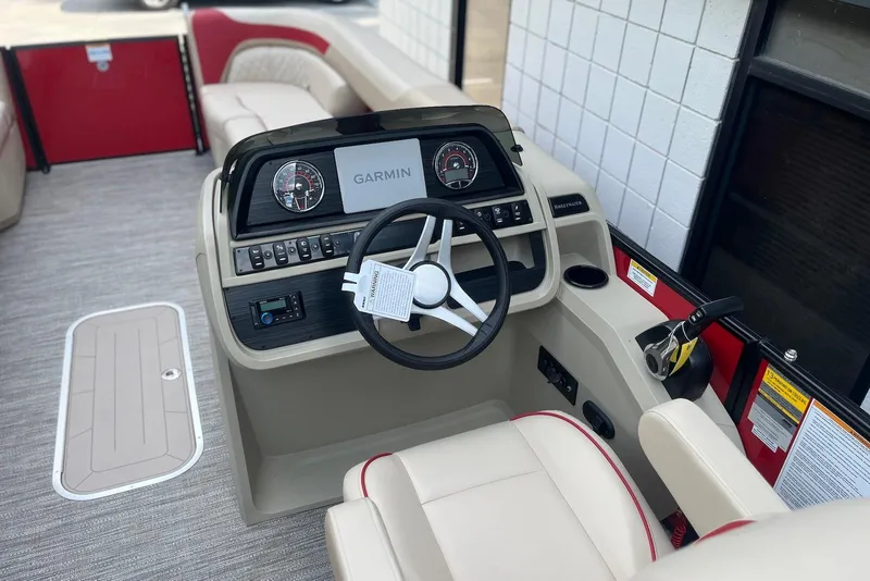 Slide: The Image of 2026 Godfrey SWEETWATER 2286 SB boat interior with Garmin navigation system and steering wheel. - 14