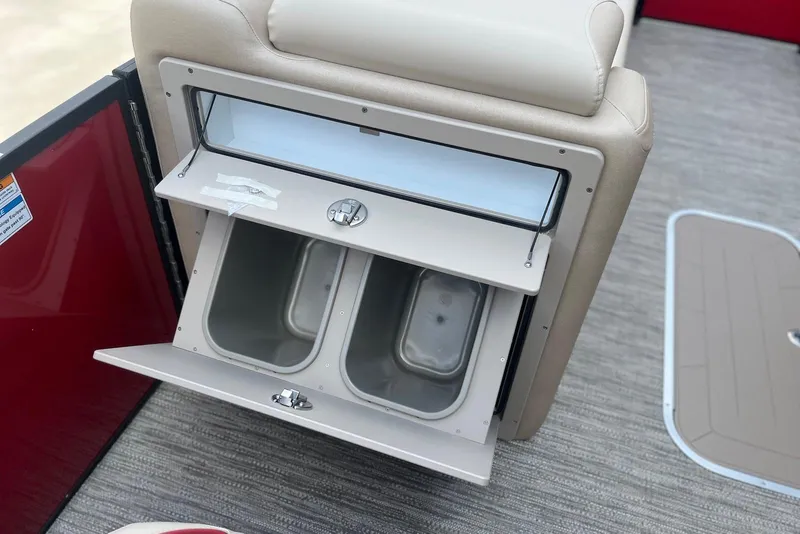 Slide: The Image of Storage compartment on 2026 Godfrey SWEETWATER 2286 SB boat, featuring dual bins and sleek design. - 18