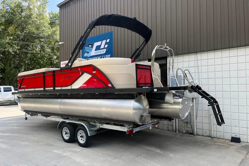 Slide: The Image of 2026 Godfrey SWEETWATER 2286 SB pontoon boat on trailer, red and beige design. - 2