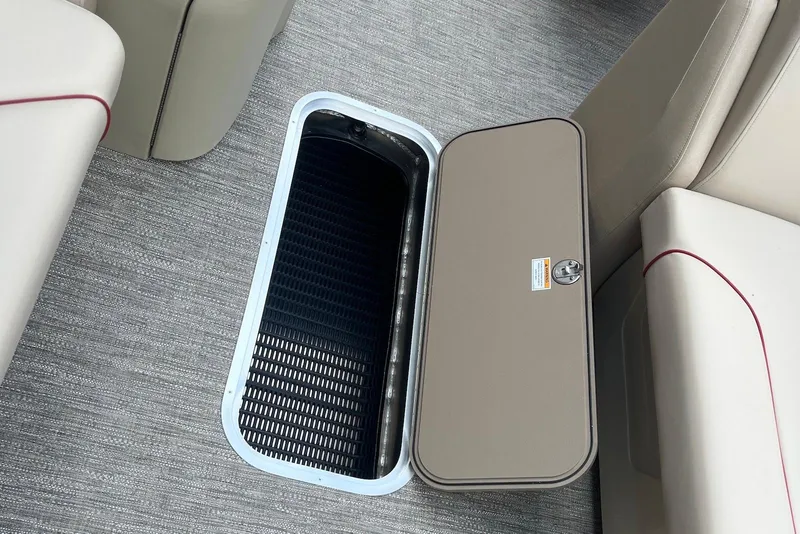 Slide: The Image of 2026 Godfrey SWEETWATER 2286 SB boat storage compartment with open hatch on carpeted floor. - 22