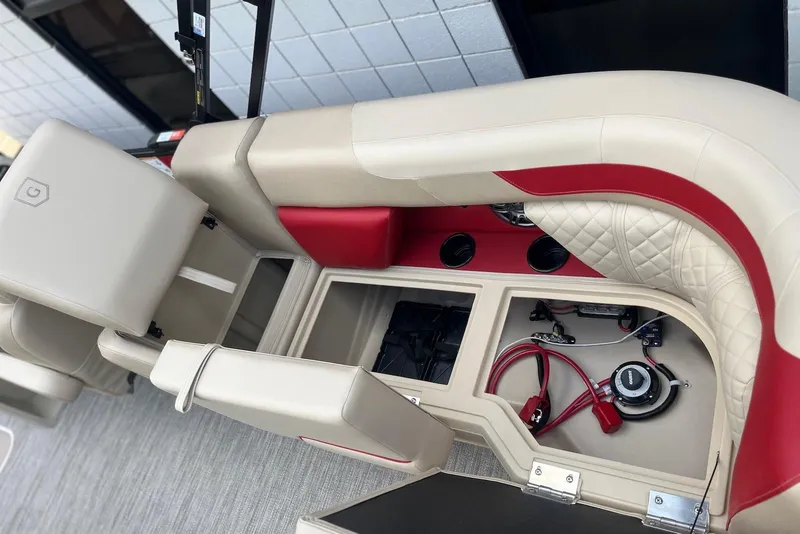 Slide: The Image of 2026 Godfrey SWEETWATER 2286 SB boat interior with storage compartments and red accents. - 23