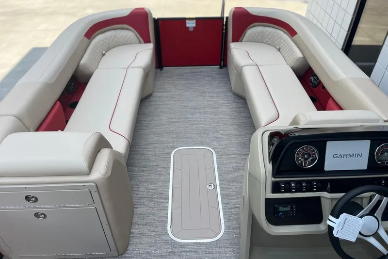 Slide: The Image of 2026 Godfrey SWEETWATER 2286 SB pontoon boat interior with beige seating and Garmin dashboard. - 24