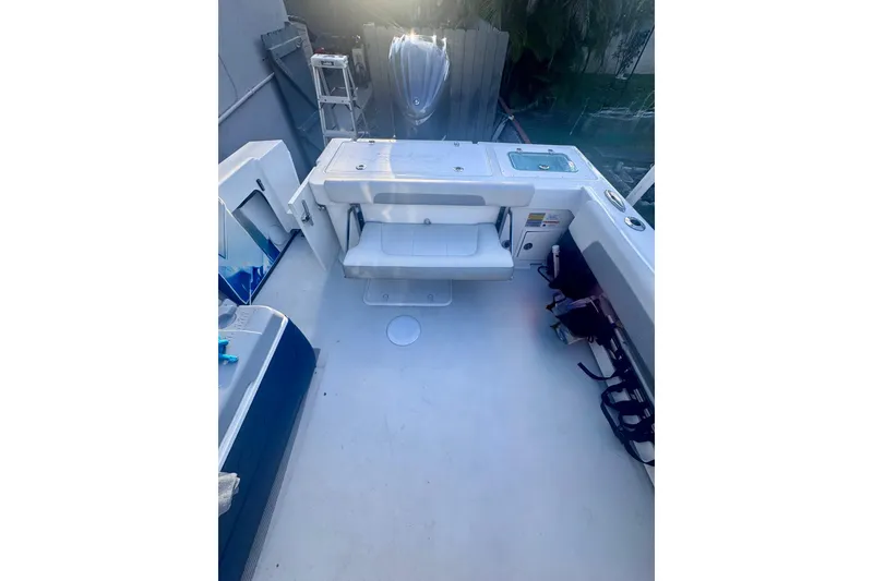 Slide: The Image of 2024 Parker 2320 Sport Cabin boat interior with seating and storage compartments. - 10