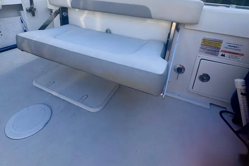 Slide: The Image of 2024 Parker 2320 Sport Cabin interior with foldable seat and storage compartments. - 11