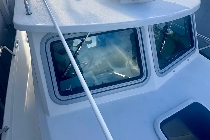 Slide: The Image of 2024 Parker 2320 Sport Cabin boat with windshield and wipers, top view. - 13
