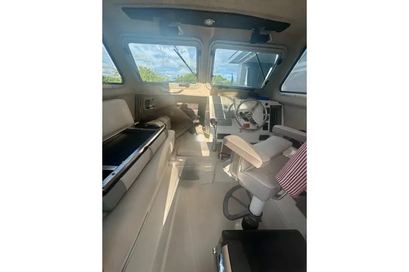 Slide: The Image of 2024 Parker 2320 Sport Cabin interior with steering wheel and seating, showcasing modern design. - 19