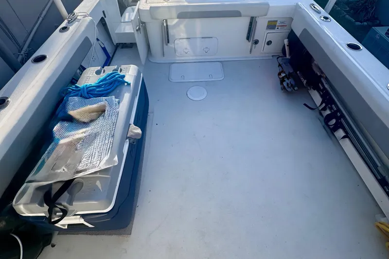 Slide: The Image of 2024 Parker 2320 Sport Cabin interior with fishing gear and storage. - 9