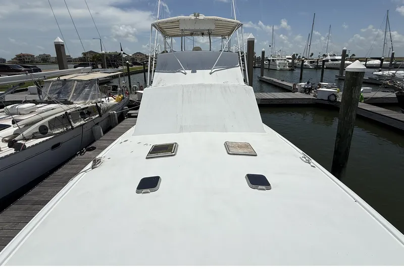 Slide: The Image of 1978 Marine Management 48 Sport Fish boat docked at marina under clear sky. - 11