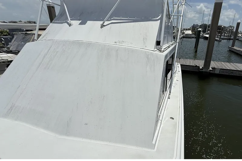 Slide: The Image of 1978 Marine Management 48 Sport Fish boat docked at marina under clear sky. - 13