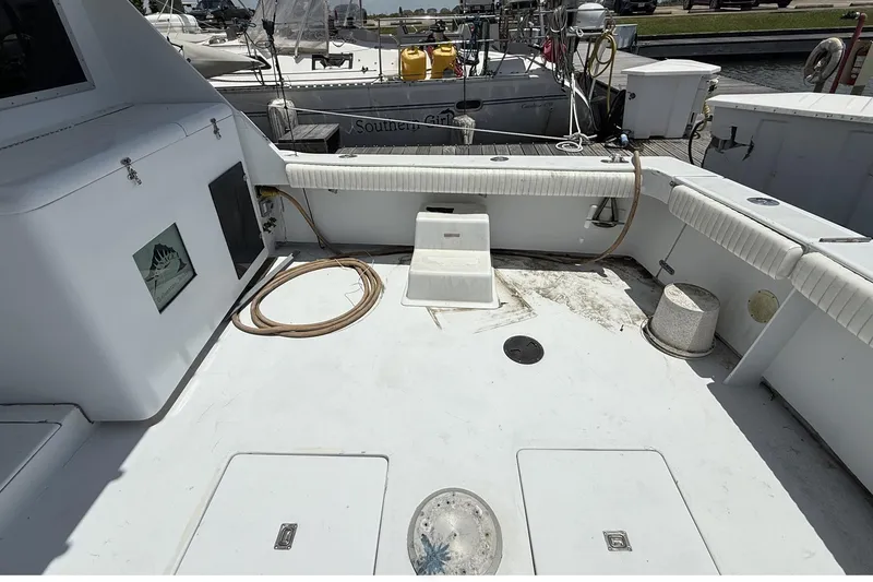 Slide: The Image of 1978 Marine Management 48 Sport Fish boat deck with seating and storage compartments. - 14