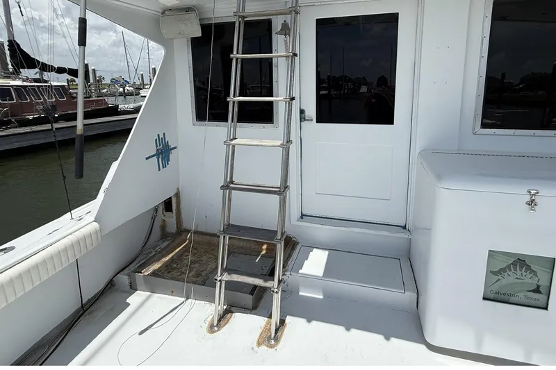 Slide: The Image of 1978 Marine Management 48 Sport Fish boat deck with ladder and storage, Galveston, Texas. - 18