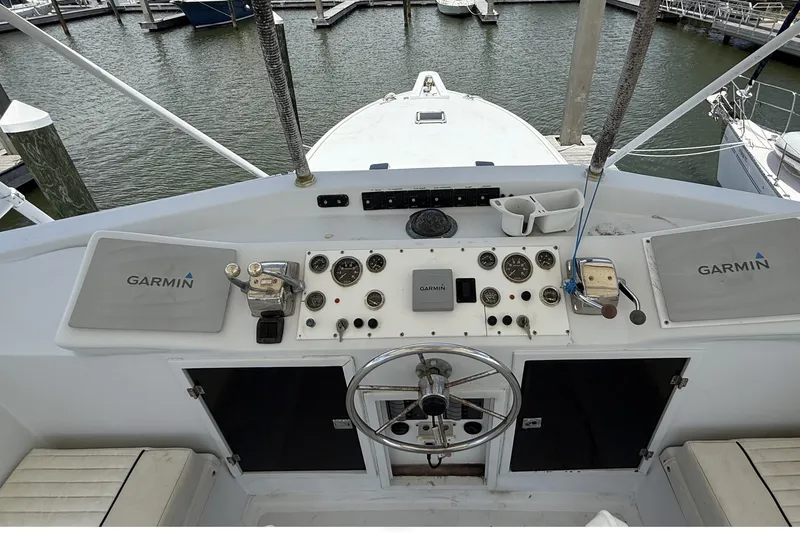 Slide: The Image of 1978 Marine Management 48 Sport Fish boat helm with Garmin navigation system in marina. - 23