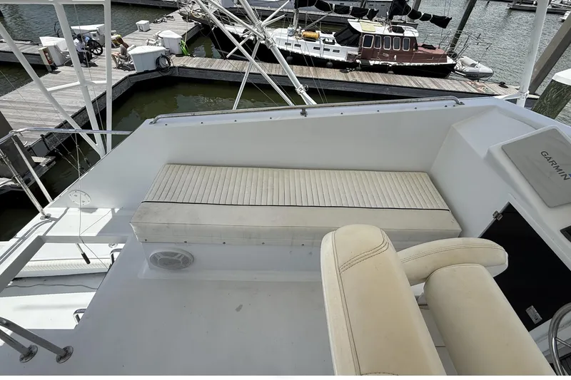 Slide: The Image of 1978 Marine Management 48 Sport Fish boat interior with seating and dock view. - 24