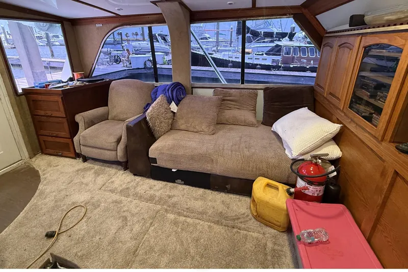 Slide: The Image of Interior of 1978 Marine Management 48 Sport Fish boat with cozy seating and marina view. - 28
