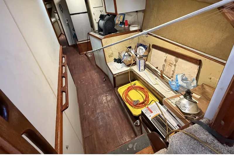 Slide: The Image of 1978 Marine Management 48 Sport Fish interior with tools and equipment on wooden floor. - 29