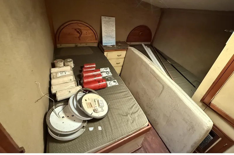 Slide: The Image of 1978 Marine Management 48 Sport Fish cabin with storage items and fishing gear. - 34