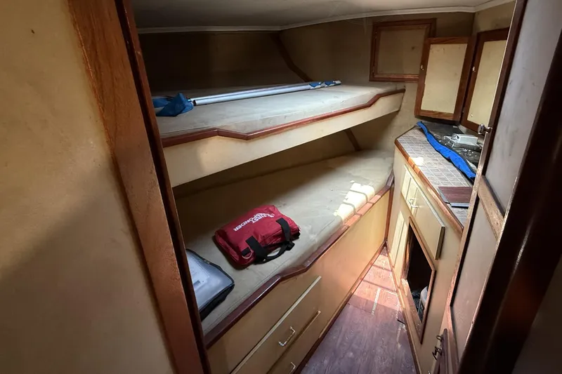Slide: The Image of 1978 Marine Management 48 Sport Fish cabin interior with bunk beds and compact kitchenette. - 35