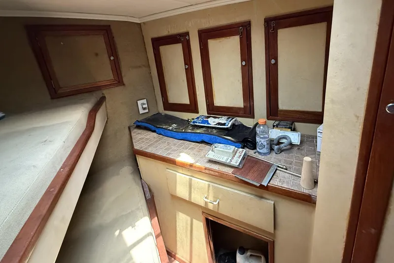 Slide: The Image of 1978 Marine Management 48 Sport Fish cabin interior with storage and workbench. - 36