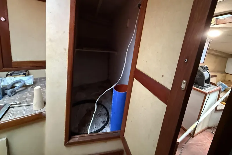 Slide: The Image of 1978 Marine Management 48 Sport Fish interior with open cabinet and tools. - 37
