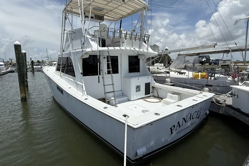 Slide: The Image of 1978 Marine Management 48 Sport Fish boat docked at marina under cloudy sky. - 6