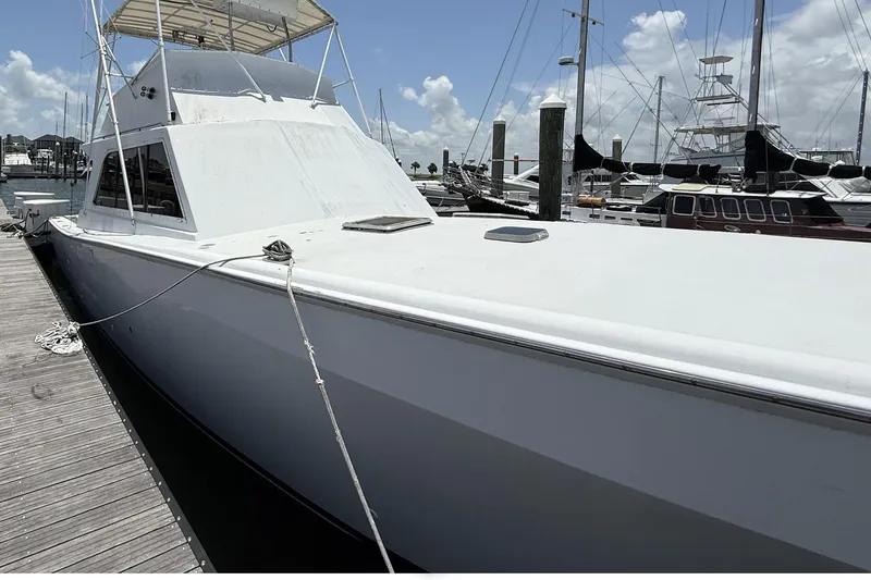 Slide: The Image of 1978 Marine Management 48 Sport Fish boat docked at marina under clear sky. - 9