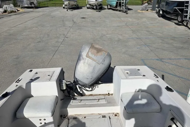 Slide: The Image of 1998 PROSPORT 20cc boat with outboard motor in a parking area. - 10