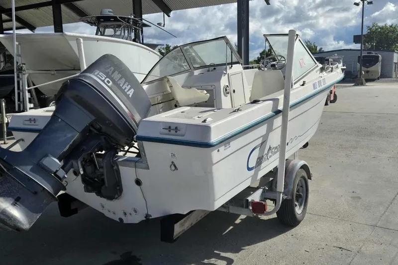 Slide: The Image of 1998 PROSPORT 20cc boat with Yamaha 150 engine on trailer in marina. - 3