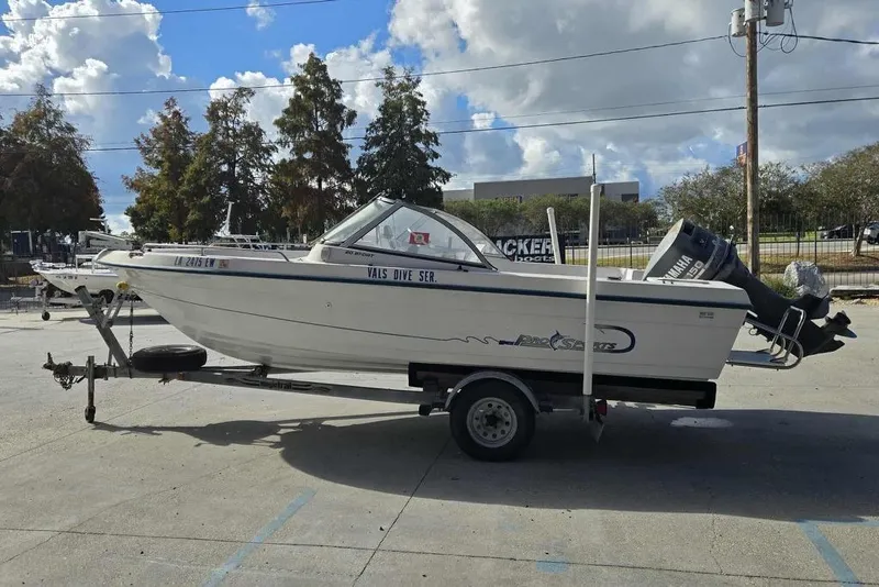 Slide: The Image of 1998 PROSPORT 20cc boat on trailer, parked outdoors under a cloudy sky. - 6