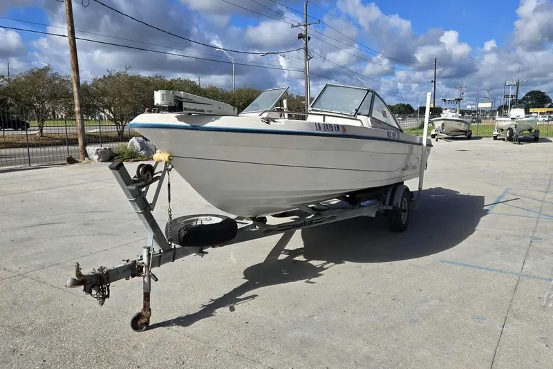 Slide: The Image of 1998 PROSPORT 20cc boat on trailer in parking lot under blue sky. - 7