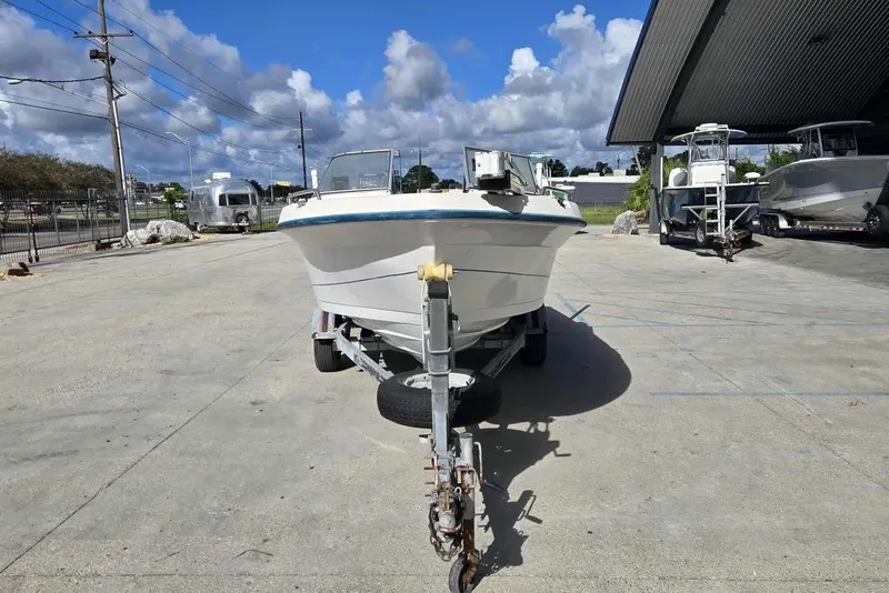 Slide: The Image of 1998 PROSPORT 20cc boat on trailer in outdoor storage area. - 8