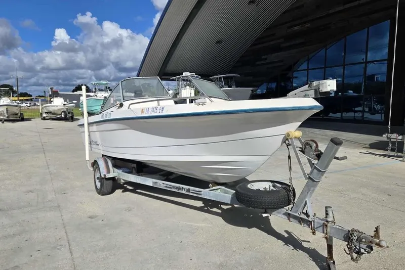 Slide: The Image of 1998 PROSPORT 20cc boat on trailer, parked outdoors under a cloudy sky. - 9