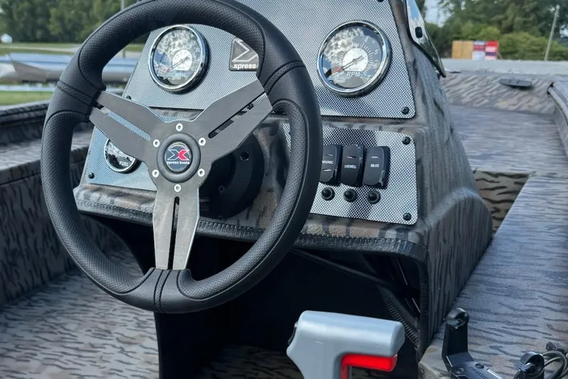 Slide: The Image of Steering wheel and dashboard of 2026 Express Xp170 boat, featuring modern gauges and controls. - 7