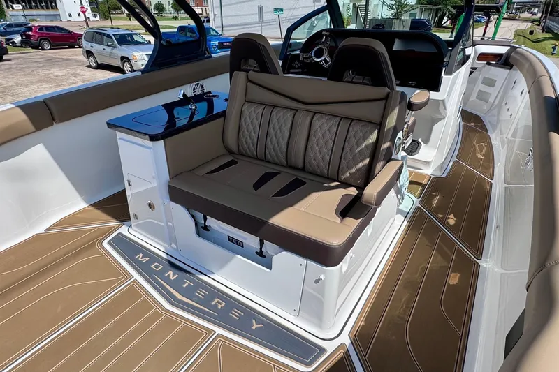Slide: The Image of 2026 Monterey Elite 30 OB boat interior with luxurious seating and sleek design. - 10