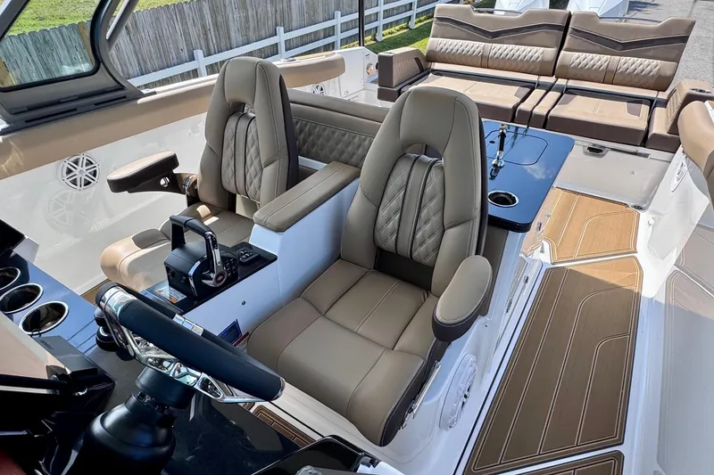Slide: The Image of Luxurious interior of 2026 Monterey Elite 30 OB boat with plush seating and modern controls. - 11