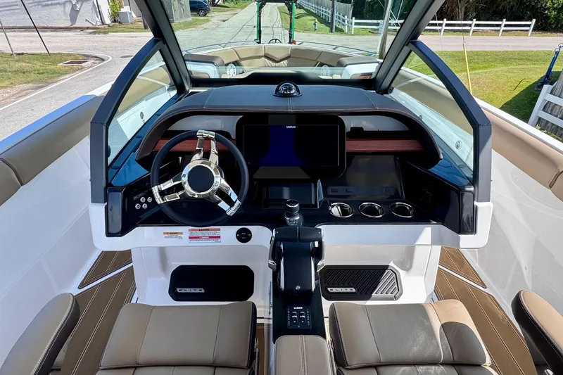 Slide: The Image of 2026 Monterey Elite 30 OB boat cockpit with modern steering and dashboard controls. - 12
