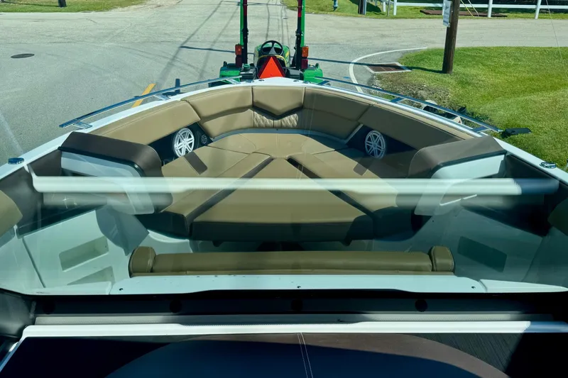 Slide: The Image of 2026 Monterey Elite 30 OB boat interior with tan seating and speakers. - 15