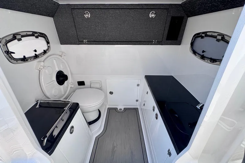 Slide: The Image of Modern bathroom interior of 2026 Monterey Elite 30 OB boat, featuring sleek design and amenities. - 19