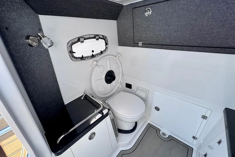 Slide: The Image of 2026 Monterey Elite 30 OB boat bathroom with modern fixtures and compact design. - 21