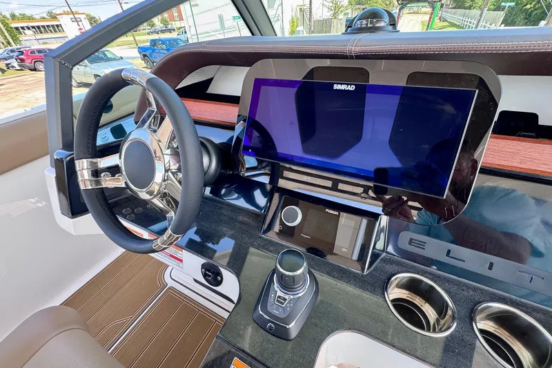 Slide: The Image of Interior dashboard of 2026 Monterey Elite 30 OB boat with steering wheel and touchscreen display. - 22