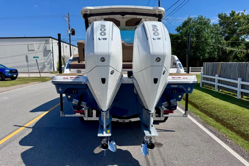 Slide: The Image of 2026 Monterey Elite 30 OB boat with dual 300 V8 engines on a sunny street. - 3